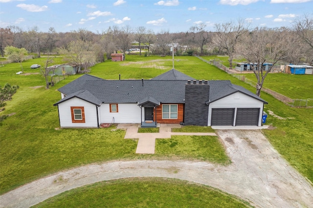 ranch-style home featuring a garage and a front lawn