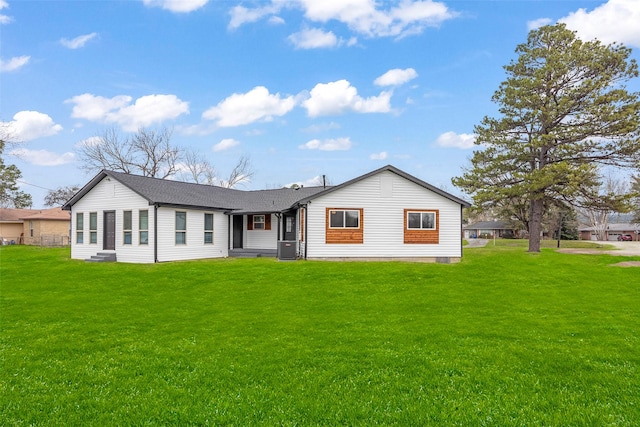 rear view of house with a lawn