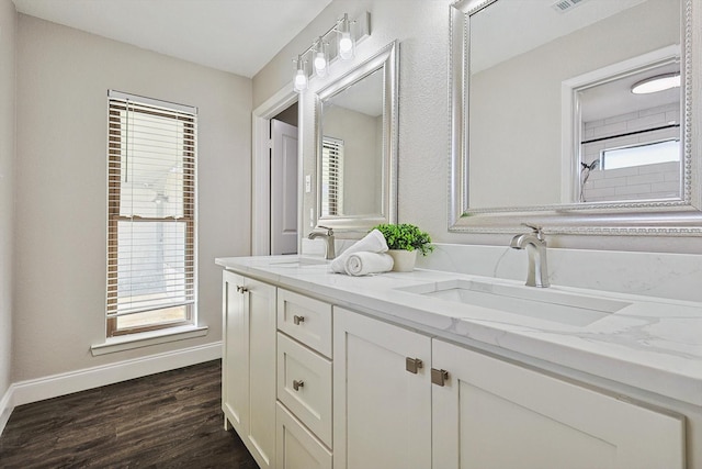 bathroom featuring vanity, hardwood / wood-style flooring, and a healthy amount of sunlight