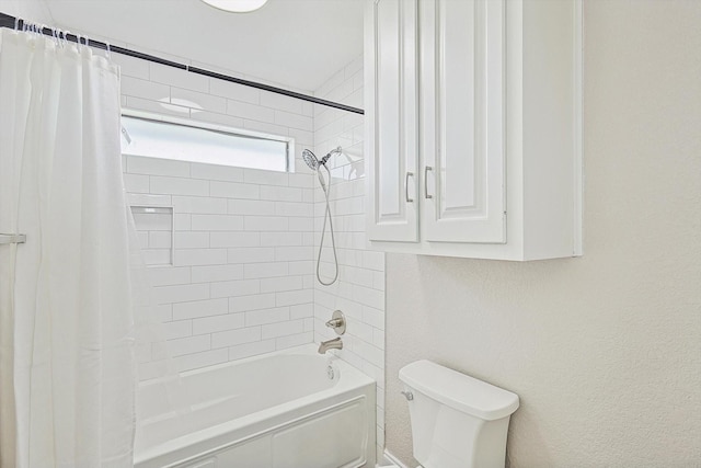 bathroom featuring toilet and shower / bath combination with curtain