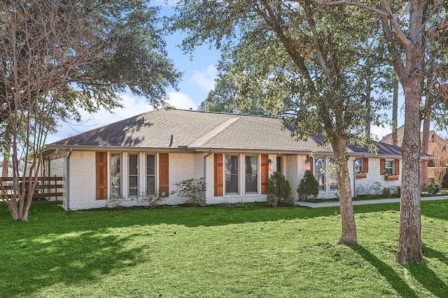 rear view of property featuring a yard