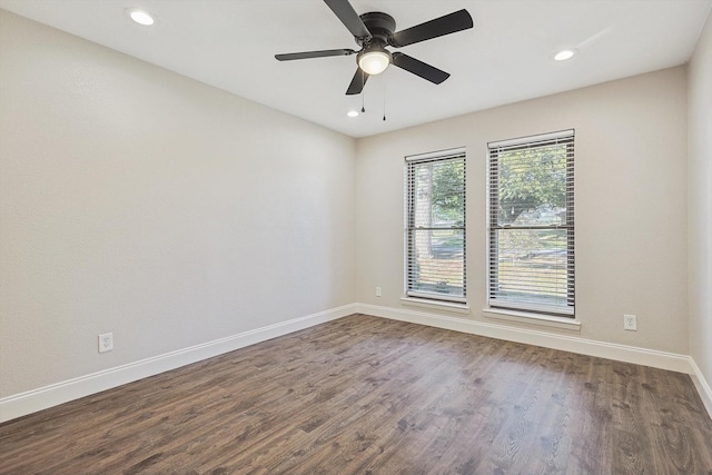 spare room with ceiling fan and dark wood-type flooring