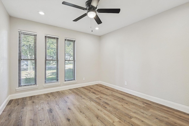 unfurnished room with ceiling fan and light hardwood / wood-style floors