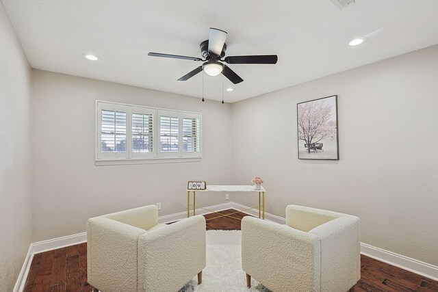 sitting room featuring ceiling fan and dark hardwood / wood-style flooring