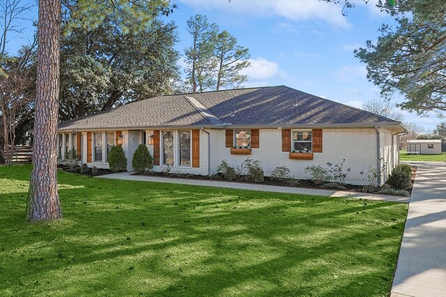 ranch-style house with a front lawn