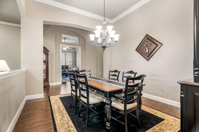 dining room featuring ceiling fan with notable chandelier, crown molding, and dark wood-type flooring