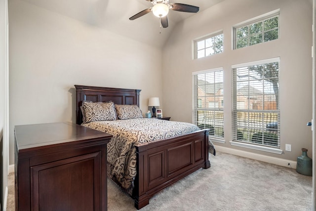 bedroom featuring ceiling fan, light colored carpet, and lofted ceiling