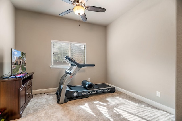 workout area featuring light carpet and ceiling fan