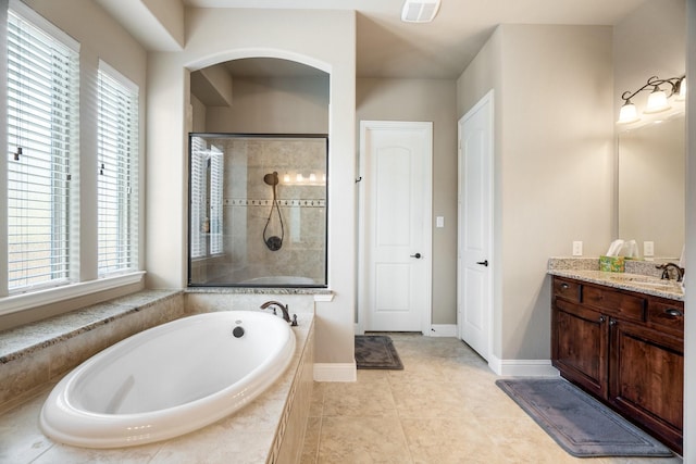 bathroom featuring tile patterned floors, vanity, and separate shower and tub