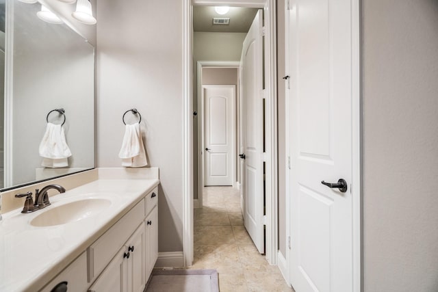 bathroom featuring tile patterned flooring and vanity