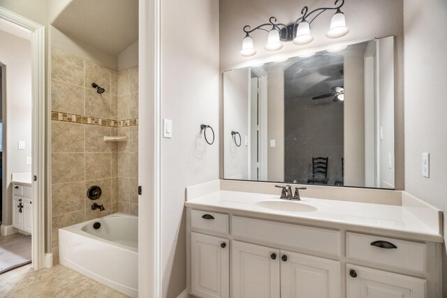 bathroom featuring tile patterned floors, ceiling fan, vanity, and tiled shower / bath