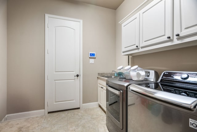 laundry room featuring cabinets, independent washer and dryer, light tile patterned floors, and sink