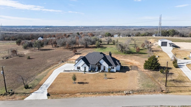 birds eye view of property with a rural view