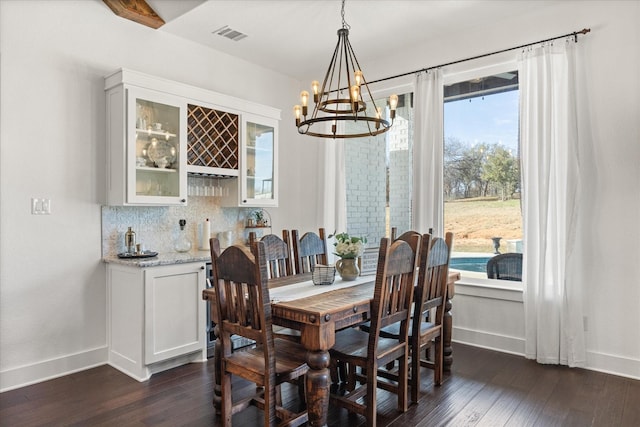 708 Glade Park Ct, Azle, TX 76020 - kitchen with an inviting chandelier, decorative backsplash, a breakfast bar, custom range hood, and appliances with stainless steel finishes