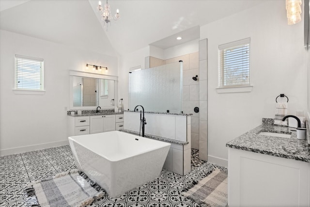 bathroom featuring tile patterned floors, vanity, plus walk in shower, and vaulted ceiling