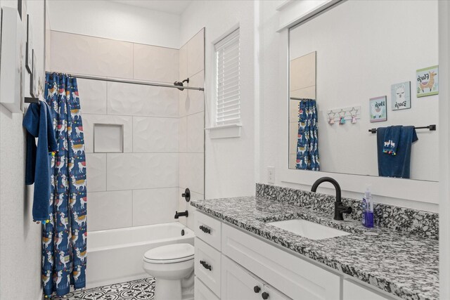 full bathroom featuring tile patterned floors, vanity, toilet, and shower / tub combo