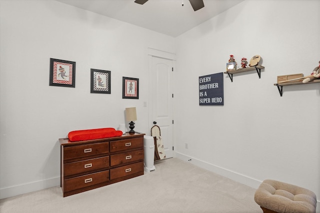 interior space featuring light carpet and ceiling fan