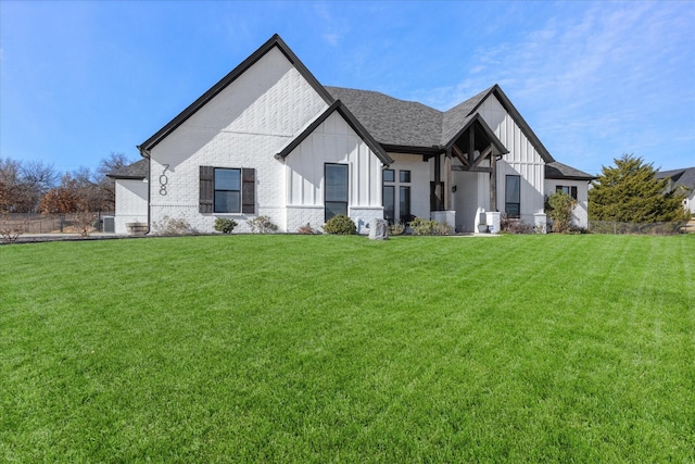 708 Glade Park Ct, Azle, TX 76020 - view of front of property with brick siding, a front lawn, roof with shingles, and board and batten siding
