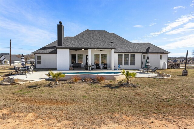 rear view of property with a patio, ceiling fan, and a lawn