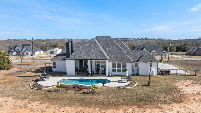 view of pool with a yard and a patio