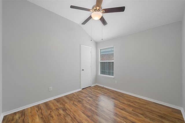 empty room with hardwood / wood-style flooring, ceiling fan, and lofted ceiling