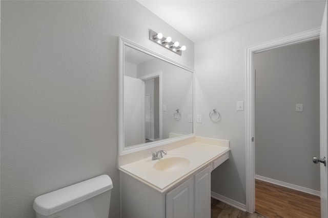 bathroom featuring hardwood / wood-style flooring, vanity, and toilet