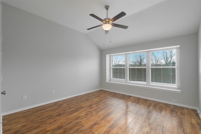 spare room featuring lofted ceiling, dark wood-type flooring, and ceiling fan