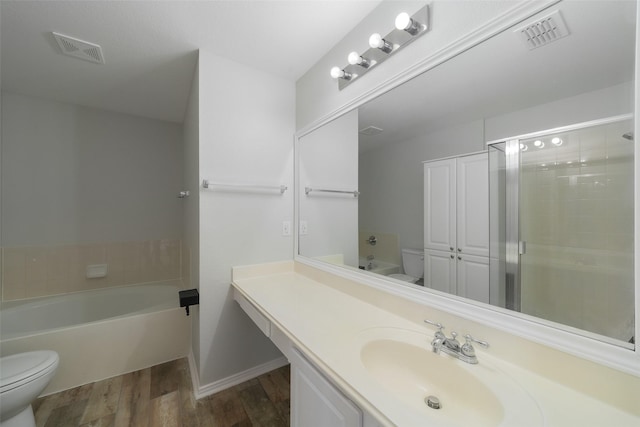 full bathroom featuring hardwood / wood-style flooring, vanity, plus walk in shower, and toilet