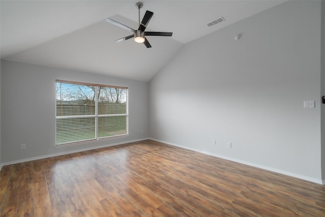 unfurnished room with vaulted ceiling, dark hardwood / wood-style floors, and ceiling fan