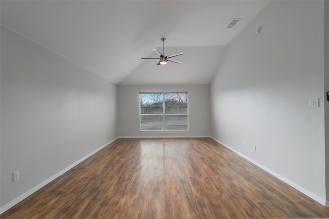 spare room with dark wood-type flooring, ceiling fan, and vaulted ceiling