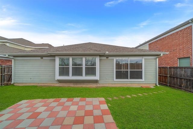 back of house with a lawn and a patio