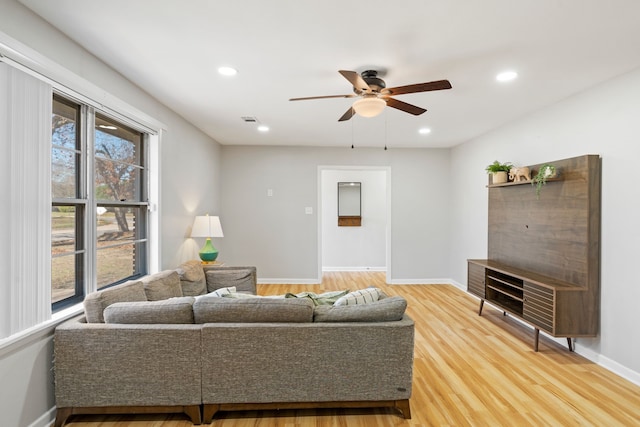 living room featuring ceiling fan and wood-type flooring