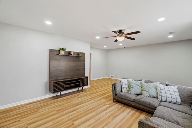 living room with ceiling fan and light hardwood / wood-style floors