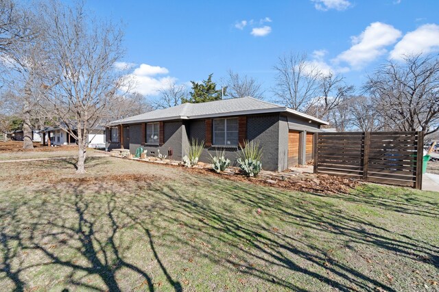 view of front of home with a garage and a front lawn