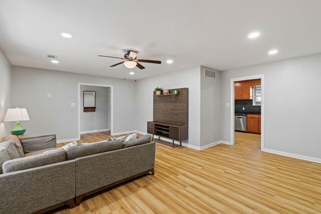 living room featuring ceiling fan and light wood-type flooring