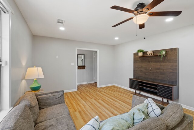 living room featuring ceiling fan and wood-type flooring