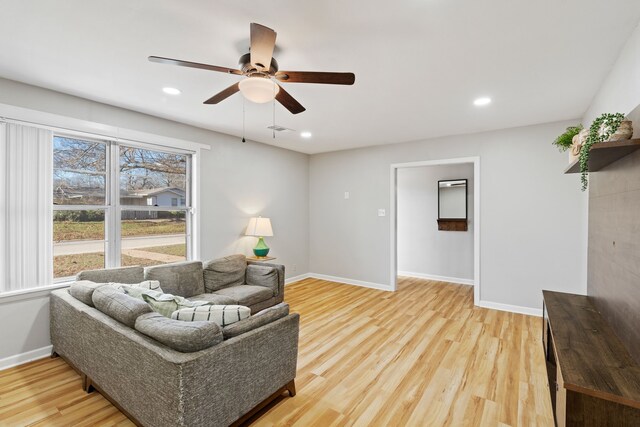 living room featuring hardwood / wood-style flooring and ceiling fan