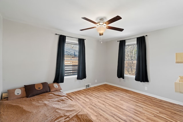 empty room featuring ceiling fan and light hardwood / wood-style flooring