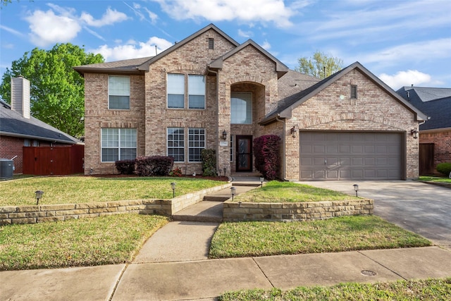 view of front of home with a garage, a front yard, and central air condition unit