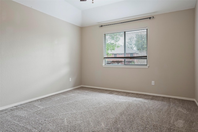 empty room with ceiling fan and carpet floors