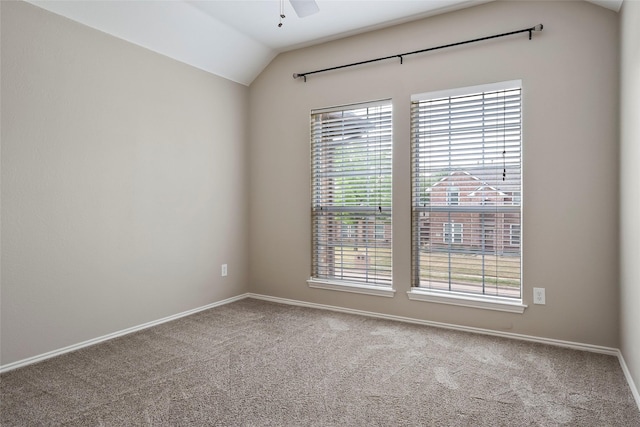 unfurnished room with carpet floors, vaulted ceiling, and ceiling fan