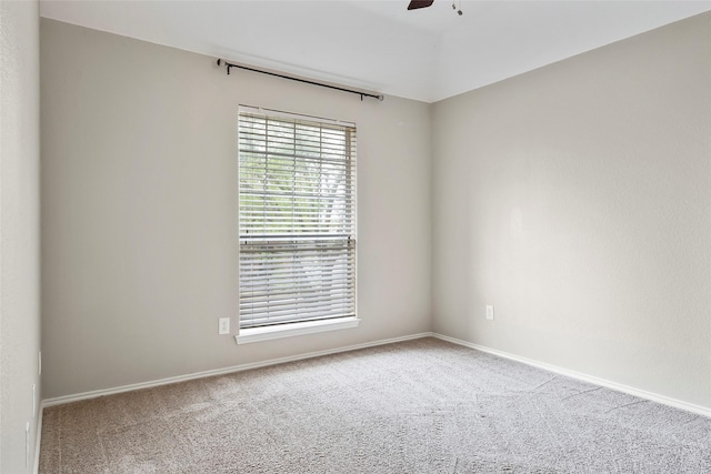 carpeted empty room featuring ceiling fan