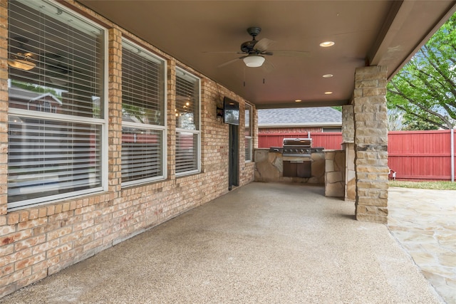 view of patio / terrace with ceiling fan, a grill, and exterior kitchen