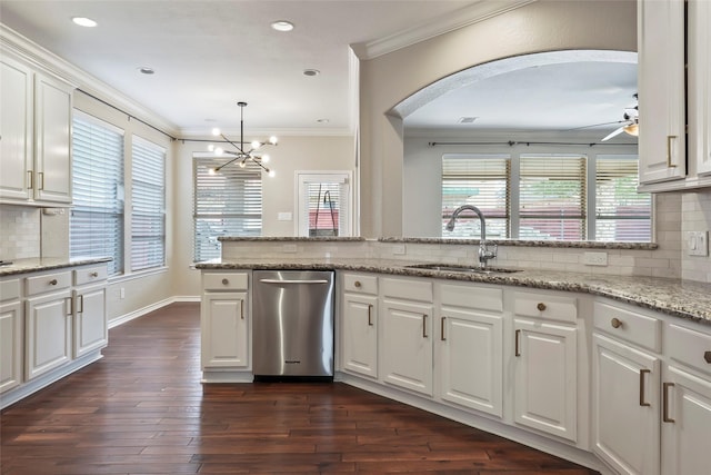 kitchen with white cabinetry, sink, and light stone countertops