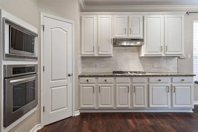 kitchen with appliances with stainless steel finishes, ventilation hood, and white cabinetry