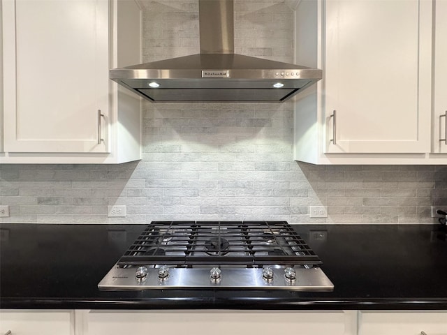 1133 Cornerstone Dr, Little Elm, TX 76227 - kitchen featuring wall chimney exhaust hood, stainless steel gas cooktop, white cabinetry, and decorative backsplash