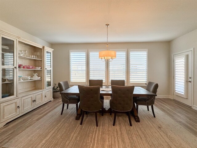 1133 Cornerstone Dr, Little Elm, TX 76227 - dining space with a chandelier, light wood-style flooring, and baseboards