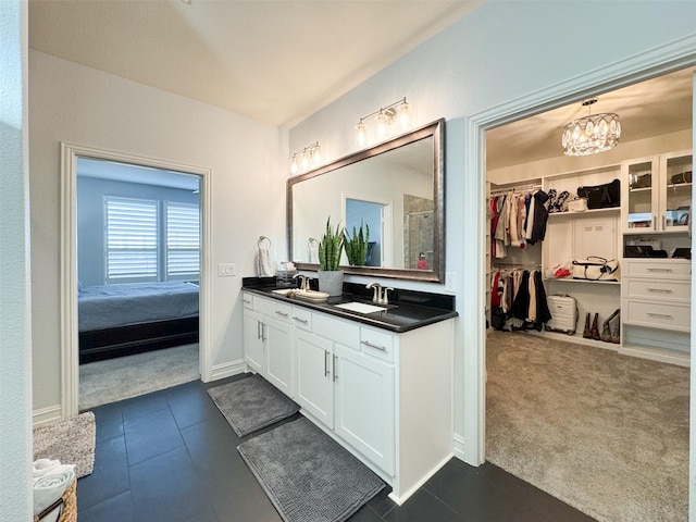 bathroom featuring vanity, an inviting chandelier, and walk in shower