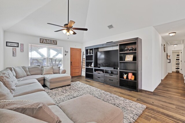 living room with built in shelves, ceiling fan, wood-type flooring, and vaulted ceiling