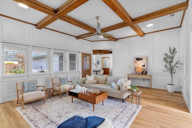 living room featuring beam ceiling, crown molding, light hardwood / wood-style flooring, and coffered ceiling